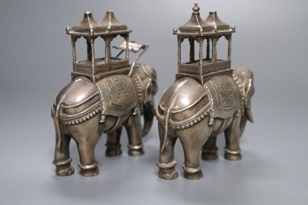 A pair of cast silver plated models of ceremonial elephants, 11cm high